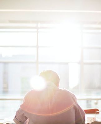 Office worker sits in conference room. 