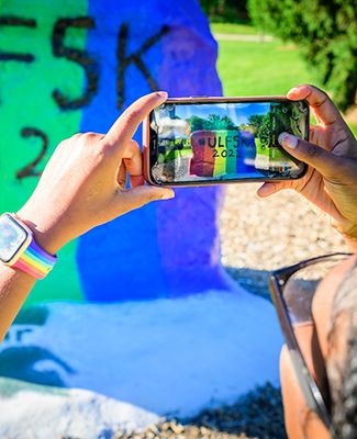 Student snapping a pic of The Rock at MSU ULF5K