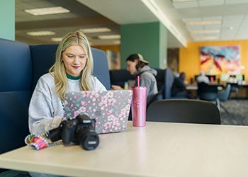Jennifer Laukonis, a student, sits behind her laptop computer in the MSU Library
