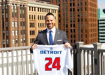 Sam Klemet on Detroit rooftop holding a #24 jersey