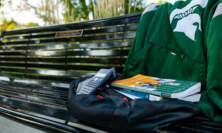 MSU memorial bench with engineering books and calculators